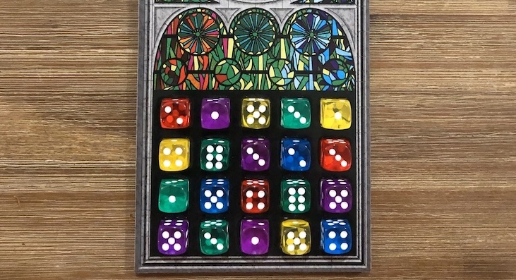 A completed game of Sagrada, showing off the variety of colors used by the translucent dice 