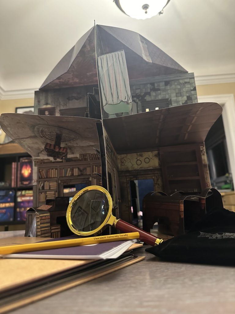 A picture of the pop-up Mystery Manor setup along with some of its components 