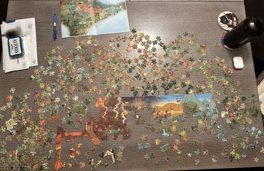 A jigsaw puzzle taking up the majority of a dining room table.